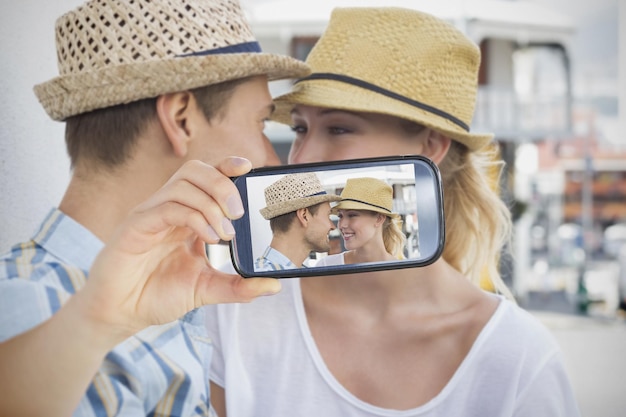 Composite of Couple taking selfie on smartphone