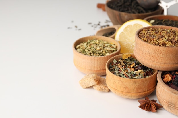 Photo concept of cooking tea with different types of tea on white background