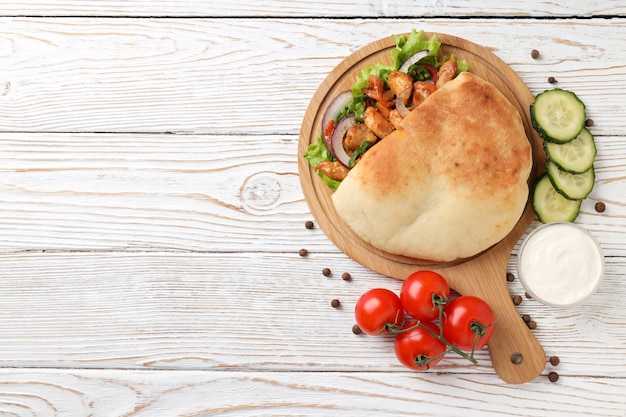 Concept of tasty food with pita with chicken space for text