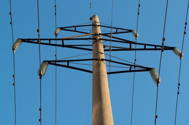 Concrete electric pole with transverse diamondshaped frames with clusters of insulators