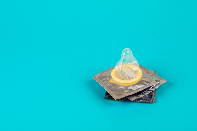 Photo condom on a blue background. the concept of safe sex.