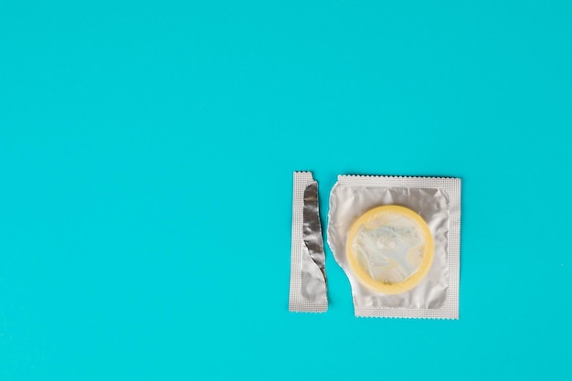 Photo condom on a blue background the concept of safe sex