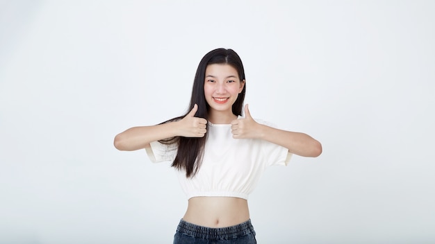 Photo confident attractive woman say yes shows thumbs up gesture of approval, like your choice, praise good thing a white background