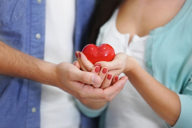 Couple hands with red heart closeup