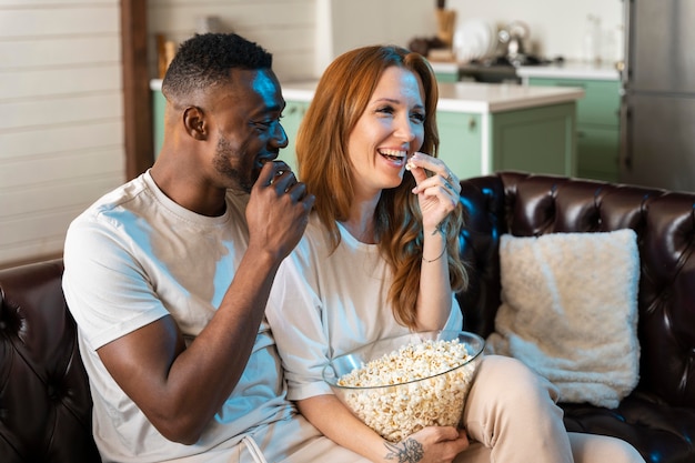 Couple watching a movie while eating popcorn