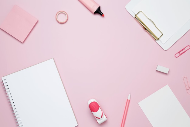 Photo creative flat lay mockup design of workspace top view composition with white notebook to do list and stationery on pink background