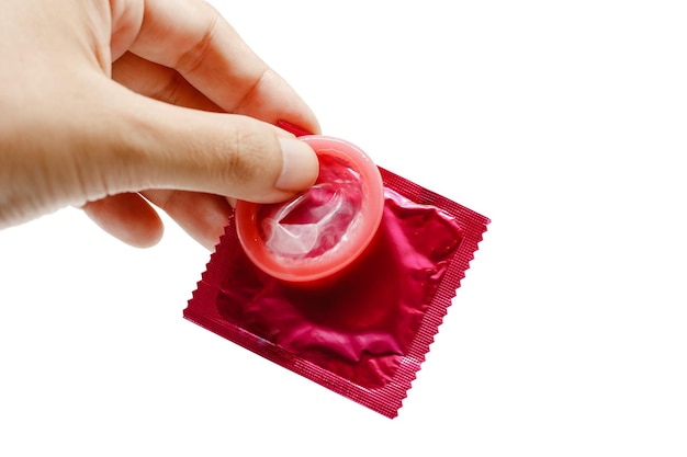 Photo cropped hand holding condom against white background