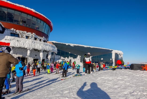 Crowd of Skiers at the Upper of Ski Lift Station in Sunny Weather