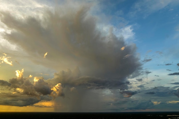 Cumulonimbus clouds forming before thunderstorm on evening sky Changing stormy cloudscape weather at sunset