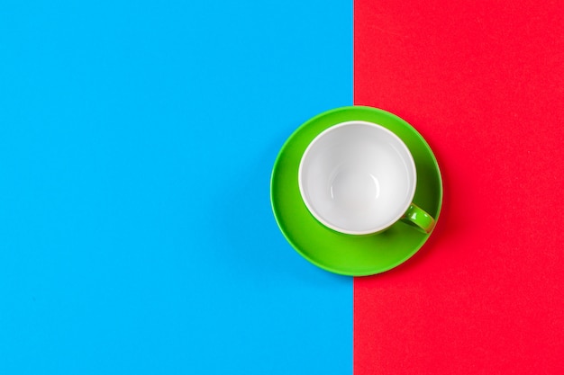 Cup of coffee and saucer on color