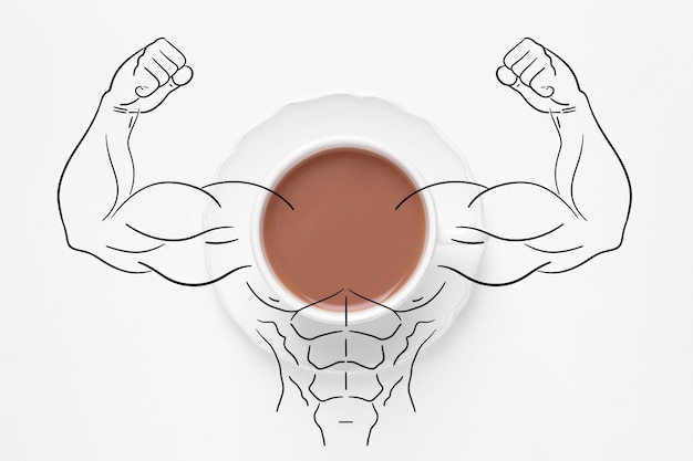 Photo cup of tasty tea with milk and illustration of bodybuilder on white background top view