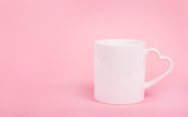 Photo cup with heart on pink background