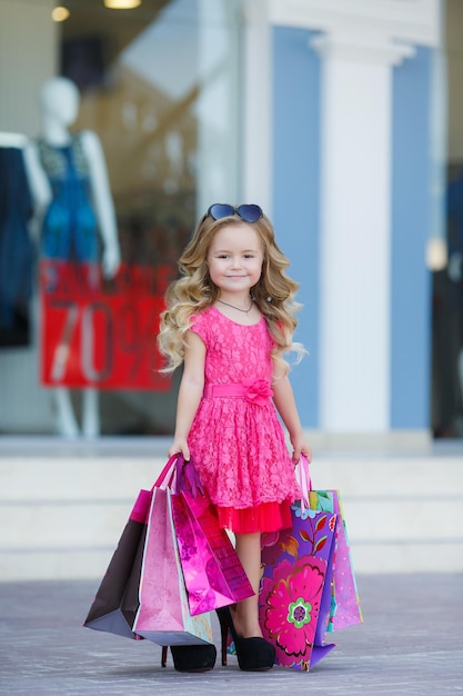 cute little girl shopping outdoors