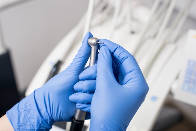 Dentist's hands with blue gloves