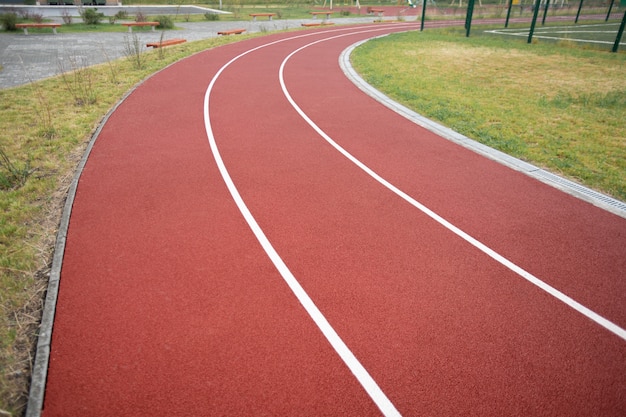 Photo diminishing perspective of stadium race track with two lines dividing it into three sections