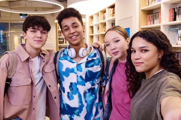 Photo diverse group of students taking selfie in school