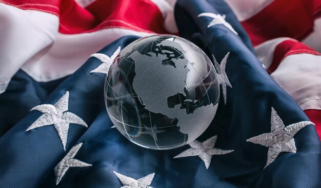 Photo earth glass globe on a ameria flag. ideal for websites and magazines layouts