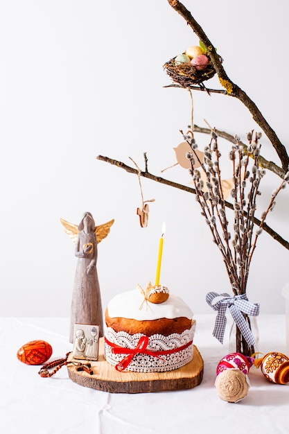 Easter cake and colored eggs on white background