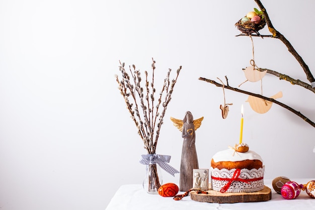 Easter cake and colored eggs on white background