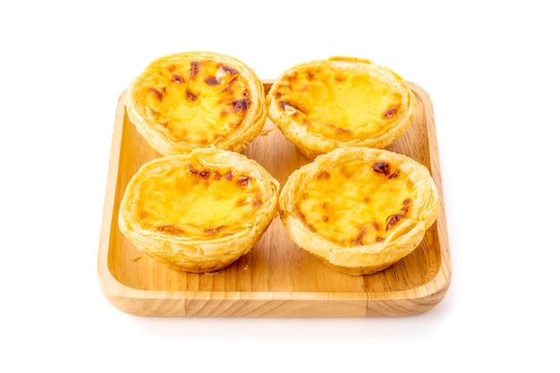 Egg tart the delicious crispy bekery on wooden plate isolated on white background