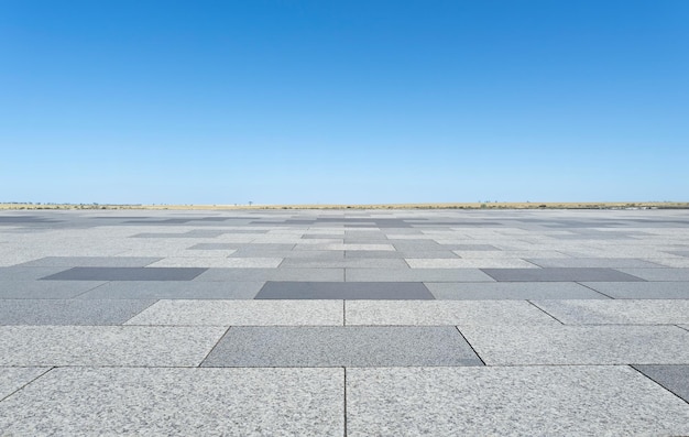 Photo empty square made of stone tiles under blue sky