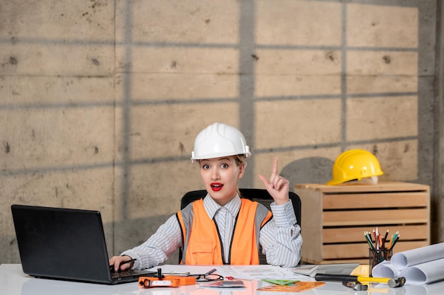 Engineer civil worker in helmet and vest smart young cute blonde girl having an idea