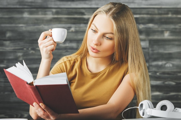 European woman reading book at desk