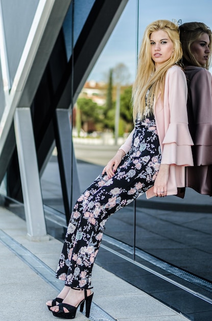 Fashion blonde model posing at the street