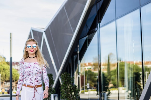 Fashion young woman businesswoman walking with sunglasses