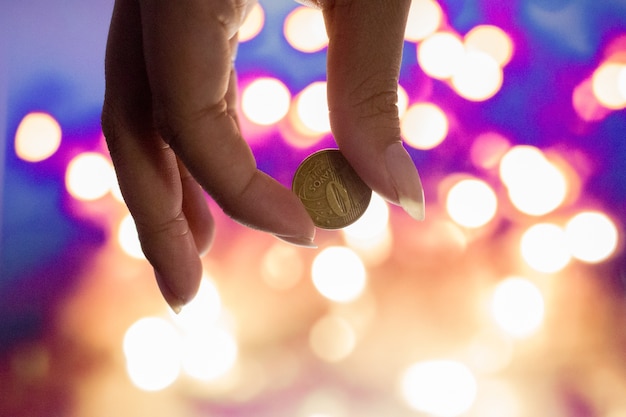 female hand holding 10 Brazilian cents