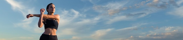 Female posing in sportswear on sky background The middle part of the body