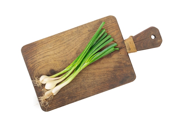 Fresh green onion on wooden board Isolated on white background Top view