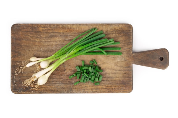 Fresh green onion on wooden board Isolated on white background Top view