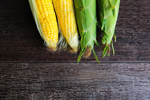 fresh sweet corn on wooden table