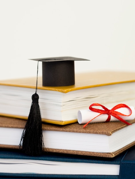 Front view academic cap on pile of books