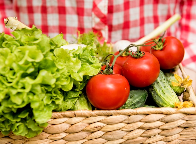 Front view bucket with tomatoes and cucumbers