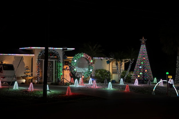 Front yard with brightly illuminated christmas decorations Outside decor of florida family home for winter holidays