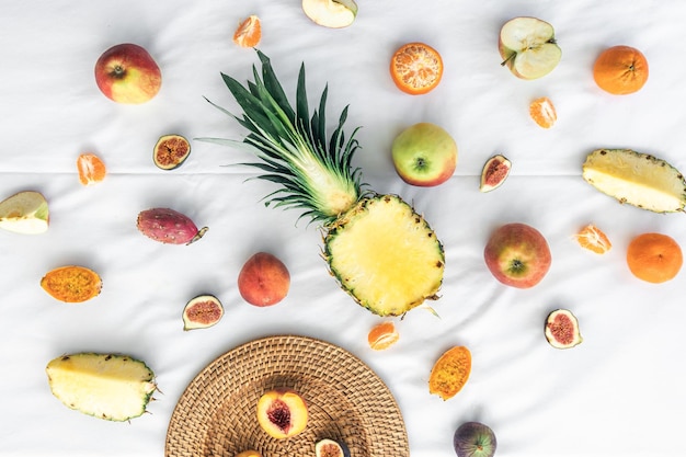 Fruit background with cut pineapple and other exotic fruits