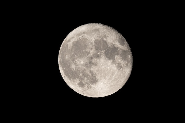 Photo full moon photographed with a telescope and reflex camera where are visible craters on the surface