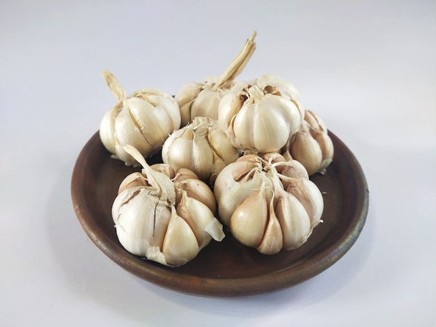 Garlic cloves in a wooden cup