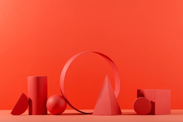 Geometric paper shapes on coral background