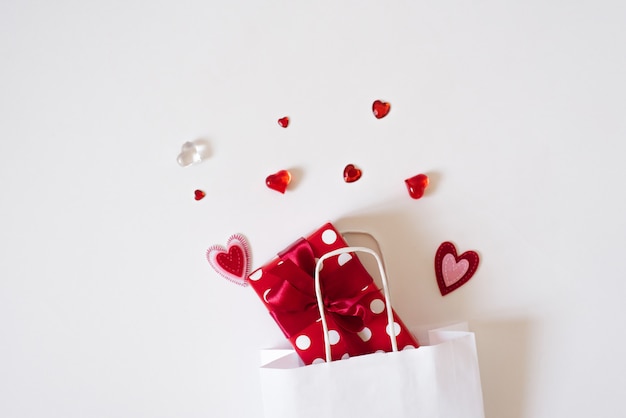 Gift bag with gifts and hearts on a white background. Concept of sales and discounts for Valentine's day