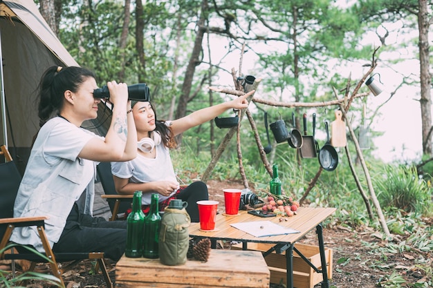 Girl and friends camping in the forest