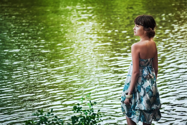 Girl staying by a lake