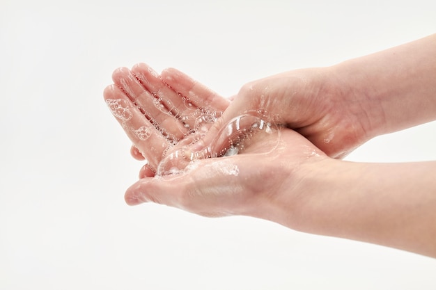 girl washing hands with soap.