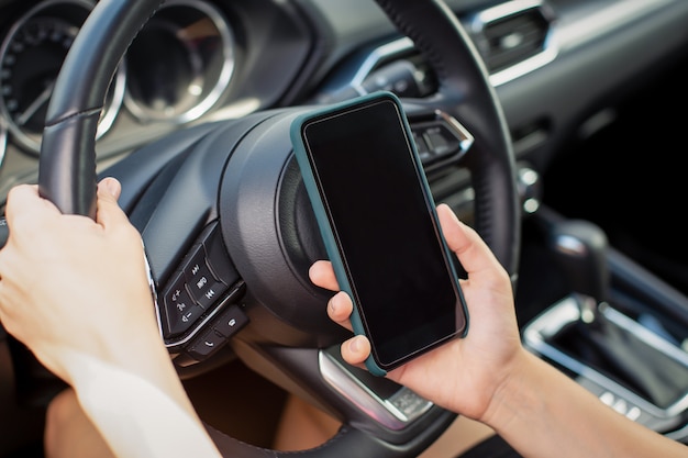 Girl with smart phone in car