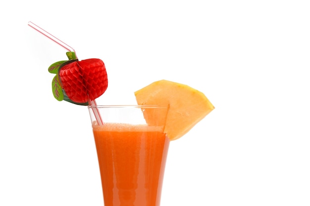 A glass of fruit juice with a straw and a strawberry on top