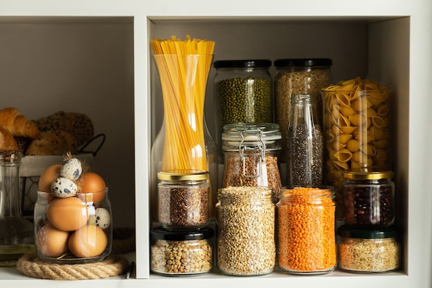 Glass jars with food. Food concept. Shelves in the kitchen. Products on the shelves. 