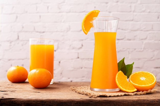 glass of orange juice on wood table.