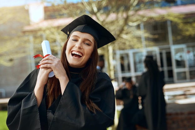 Photo graduate portrait and excited woman with degree at university success or achievement in australia female student happy and proud with diploma for goal certificate or award on campus for ceremony